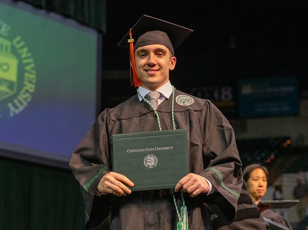 A flippable tile for graduate students. There's information on the application process on the back. There's a button that links to the relevant application at the end of the section.